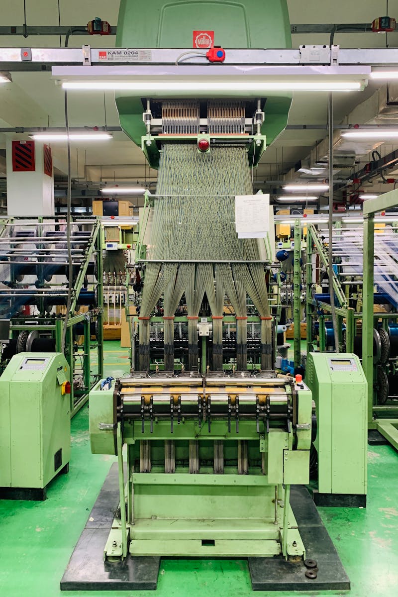 High-tech textile machine in Mymensingh factory producing yarn.